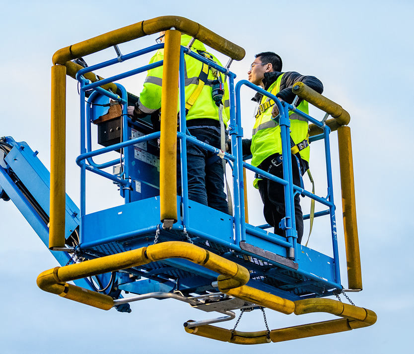 Workers in a bucket lift