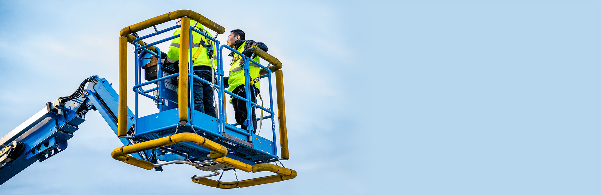 Workers in a bucket lift